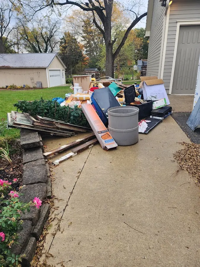 Dumpster being loaded with debris for 12 Yard Dumpster Rental in Warren